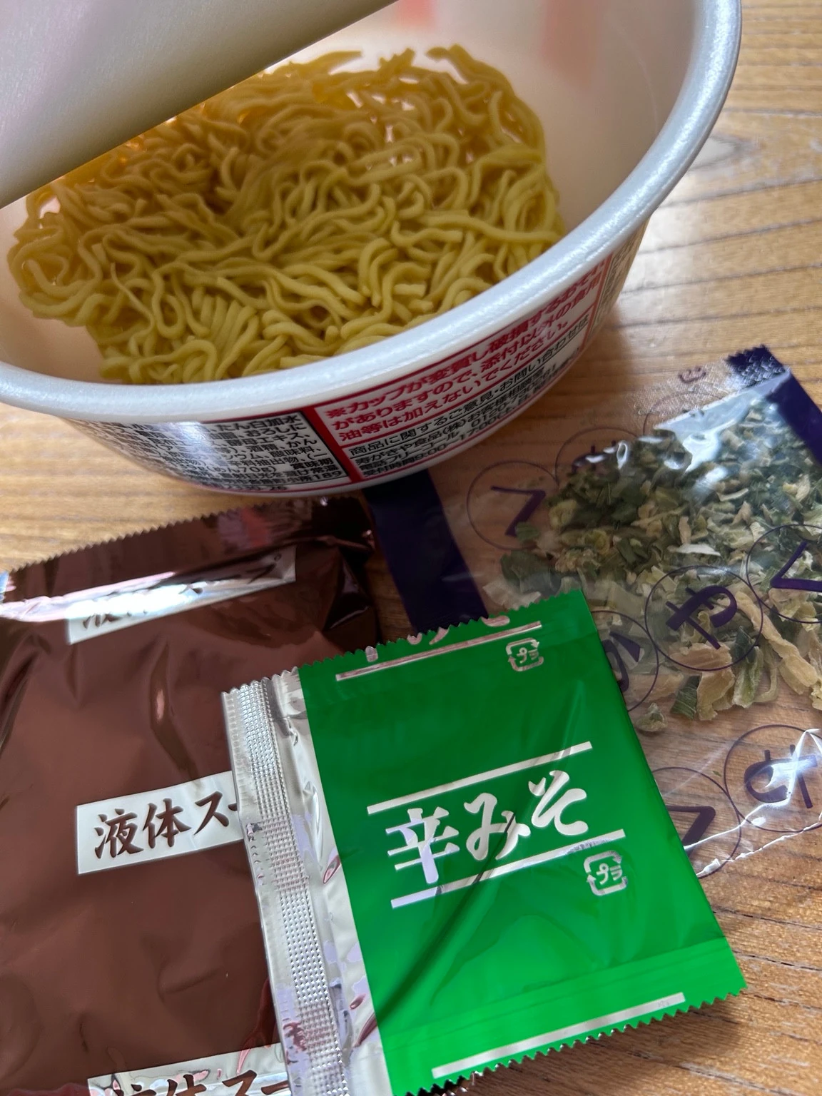 開封した麺と液体スープ・辛みそ・かやくの小袋